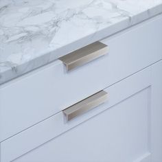 a white marble counter top with two drawers