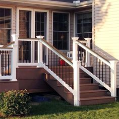 a house with white railings and windows