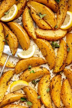 baked potato wedges with lemon slices and herbs