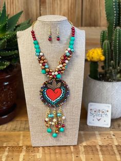 This beautiful Mexican jewelry is handmade by Mexican Artisans and completely one of a kind. The combination of pearls add a feminine touch to your outfit. The pendant is made of leather and hand painted. This jewelry is truly a work of art! The set includes a necklace and earrings. Mexican Necklace, Multicolor Necklace, Mexican Jewelry, Traditional Earrings, Summer Attire, Unusual Jewelry, Fashion Jewelry Sets, Jewelry Lookbook, Colorful Jewelry