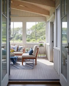 an open porch with furniture and large windows