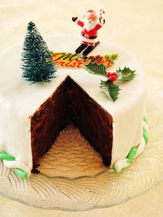 a cake decorated with white frosting and christmas decorations