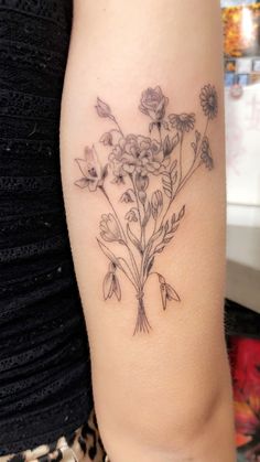 a woman's arm with flowers on it