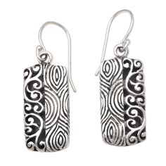 Half fingerprint motif half curling vine Wayan Asmana's dangle earrings are 100% fun. Balinese artisans use sterling silver to create the earrings engraving the precious metal with two distinct patterns in a combination finish. Artistic Etched Earrings As A Gift, Silver Artisan Earrings With Artistic Design, Artisan Silver Earrings With Artistic Design, Adjustable Sterling Silver Jewelry With Artistic Design, Artisan Sterling Silver Etched Earrings, Engraved Sterling Silver Adjustable Earrings, Artisan Etched Sterling Silver Earrings, Sterling Silver Artistic Earrings For Gift, Artistic Sterling Silver Earrings As Gift