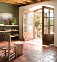 a living room filled with furniture and wooden doors