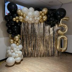 balloons and streamers in the shape of numbers are on display at an office party