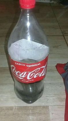 a bottle of coca cola sitting on the floor