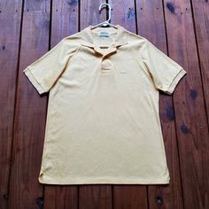 Vintage 80's men's size Large short sleeve polo shirt by Sears!! Embroidered fire breathing dragon in front. Pale light soft yellow color. Banded sleeves. Soft material. Collar with a few buttons down the front. Great vintage condition. Has been washed and will be pressed. Happy to answer any questions :) Measurements: Pit to pit - 20 1/2 inches across.  Length from shoulder to hem - 27 1/2 inches. Yellow Collared Polo Shirt For Summer, Yellow Polo Shirt With Collar For Summer, Summer Yellow Polo Shirt With Polo Collar, Yellow Summer Polo Shirt, Vintage Summer Polo Collar T-shirt, Yellow Polo Shirt For Spring, Yellow Short Sleeve Polo Shirt For Spring, Yellow Spring Polo Shirt, Spring Yellow Polo Shirt