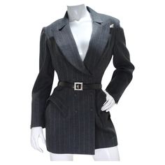 Step into the world of high fashion with our Thierry Mugler Couture 1990s Blazer, Skirt, and Belt Set. This iconic ensemble encapsulates the essence of Mugler's legendary design aesthetic, marrying structure with whimsy and commanding attention with every step. The super-structured grey pinstripe blazer is a masterpiece in itself, boasting the unmistakable Mugler silhouette. Dart detailing at the bust and shoulder pads create a powerful and confident look. Adjustable buttons at the waist ensure Mugler Clothes, Thierry Mugler Couture, Mugler Couture, Blazer Belt, Vintage Thierry Mugler, Ensemble Blazer, Blazer With Belt, Pinstripe Blazer, Vintage Suits