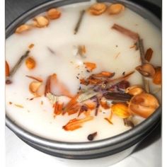 a bowl filled with milk and nuts on top of a table