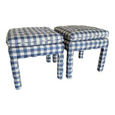 two blue and white checkered stools sitting next to each other on a white background