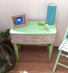 a green table and two chairs in a room