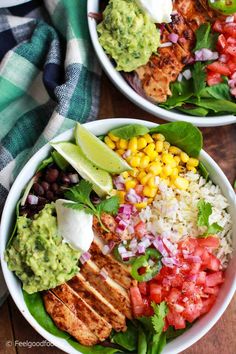 two bowls filled with chicken, rice and veggies on top of a wooden table