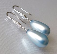 Light Blue Blush Blue Teardrop Pearl Sterling Silver Dangle Wedding Bridal Earrings. PLEASE READ ITEM DESCRIPTION and SHOP POLICIES before placing your order, and contact me with any questions! EARRINGS are about 1.22 inch (3.1cm) from top of earring wire to bottom. BRIDAL BRACELETS SECTION: https://www.etsy.com/shop/LanaChayka?ref=seller-platform-mcnav&section_id=11638942 BRIDAL EARRINGS SECTION: https://www.etsy.com/shop/LanaChayka?ref=seller-platform-mcnav§ion_id=11638940 BRIDAL JEWELRY SETS SECTION: https://www.etsy.com/shop/LanaChayka?ref=seller-platform-mcnav§ion_id=25839214 BRIDAL NECKLACES SECTION: https://www.etsy.com/shop/LanaChayka?ref=seller-platform-mcnav§ion_id=11638944 Elegant and classy, these beautiful earrings are perfect for weddings or special occasions such as birthday Blue Bridal Jewelry, Blue Earrings Wedding, Blue Bridal Earrings, Pearl Wedding Earrings, Pearl Teardrop Earrings, Blue Wedding Jewelry, Pearl Earrings Wedding, Pearl Jewelry Wedding, Bridal Earrings Pearl