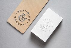 two wooden business cards on top of each other with the logo for bran & crumbs