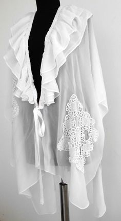 White romantic cloak,Boho tunic, Poncho fashion Boho Chic, Sweet art to wear, only 1 piece in stock, handmade. materials: white silk chiffon; Victorian lace, hand crocheted. This beautiful Boho style cloak is light and airy and is made of white silk chiffon and hand-knitted Victorian cotton lace. Around the neckline there is a double steering wheel, which is based on hand-knitted lace. are tied with two strips of fabric. On the left front there is a pocket made of square lace. The length of the Handmade Bohemian Shawl For Spring, Bohemian Beach Cape For Spring, Bohemian Cape Shawl For Summer, Bohemian Summer Cape Shawl, One Size Shawl Cape For Beach, Bohemian Summer Cape One Size, Bohemian One-size Cape For Summer, Handmade Bohemian Shawl For The Beach, One Size Bohemian Cape For Spring