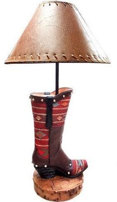 Cowboy Red Boot Table Lamp A true western lamp featuring a resin red cowboy boot . Ships with lamp shade shown. 7.7" X 7.3" X 22.4" Western Lamp, Western Lamps, Western Candle Holders, Western Picture Frames, Western Candles, Smith And Western, Lounge Pillow, Western Rings, Western Prints