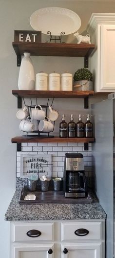 a kitchen with white cabinets and open shelving above the coffee maker is shown in this image