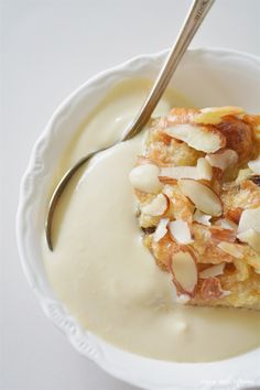 a white bowl filled with pudding and almonds