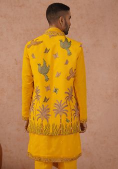 Make a striking impression with Yellow jacket Kurta. Crafted from luxurious georgette, the jacket features intricate resham and sequinned embroidery work and paired with a yoke design kurta. Fashioned with a same-color embroidered dupatta and trouser, this ensemble ensures both style and comfort with its pure lining. Perfect for Sangeet, Mehendi, Haldi, or as a wedding guest outfit. Composition : Jacket, Kurta, Trouser & Dupatta : Viscose Georgette Care: Dry Clean Only and Vacuum Storage This pr Fitted Bandhgala With Traditional Drape For Spring, Designer Embroidered Bandhgala With Straight Kurta, Spring Bandhgala With Floral Embroidery, Spring Floral Embroidery Bandhgala, Silk Nehru Jacket With Zari Work For Reception, Fitted Bandhgala Straight Kurta For Spring, Bollywood Bandhgala With Floral Embroidery For Transitional Season, Designer Silk Fitted Outerwear, Festive Silk Nehru Jacket For Reception