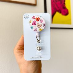 *Candy Hearts Badge Reel - Featuring cute, classic candy hearts in vibrant colors. This badge holder would make the perfect gift for the Valentines and Galentines in your life! *Our badge reel is designed with quality in mind. Retractable design and smooth extension lets you pull your badge freely with ease. *The 24in retracting cord is durable and the 1.25 in diameter case is lightweight. This holder is an essential just like you! *Perfect size to stay in secure in place and hold your id badge Valentines Badge Reel, Cheap Multicolor Novelty Badge Reel, Personalized Novelty Badge Reel For Gift, Novelty Pink Badge Reel, Personalized Pink Novelty Badge Reel, Galentines Gifts, Cute Badge Reel, Classic Candy, Candy Hearts