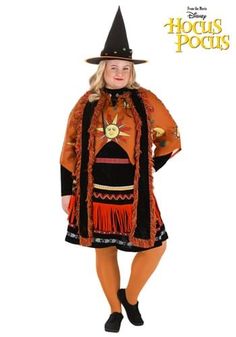 a woman in a witch costume is posing for the camera with her hands on her hips