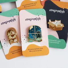 Gaze out the window into the tranquil night. A feline companion sits on the sill to watch the moon with you. An enamel pin to add flair to your collar, jacket, or bag. Perfect for collecting, displaying, or gifting to a friend! The pin is made with hard enamel and polished gold-colored metal plating. It has two posts on the back for extra security and comes with rubber clutch backings. • 1.25" Hard enamel pin• 2 Posts with rubber clutches• Designed by @occasionalish Enamel Pin Backing Card Design, Enamel Pin Ideas, Enamel Pins Packaging, Pins For Bags, Diy Drink Gifts, Enamel Pin Design, Soup Store, Stars Gold, Pin Card