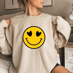 "Smiley Faces Sweatshirts, Cute Smiley Face Sweater, Smiling Emoji Tee, Positive Vibes,Happy Face, Retro Smiley Face Shirt,Emoji Face Shirts Welcome to the different, crazy and colorful world of ORANGE WORLD :) PRODUCT DETAILS Collar, shoulders, armholes, cuffs and hem double-needle stitched  -  1 x 1 rib with spandex Features a crewneck -  Relaxed fit - Unisex -  50% cotton 50% polyester HOW TO ORDER 1- Please review all photos, 2- Choose your size and color from the drop-down menus, 3- Click t Cute Long Sleeve Smiley Face Top, Fun Crew Neck Top With Smiley Face, Fun Smiley Face Crew Neck Top, Trendy Long Sleeve Tops With Smiley Face, Playful Crew Neck Top With Smiley Face, Playful Smiley Face Crew Neck Top, Funny Smiley Face Crew Neck Tops, Relaxed Fit Smiley Face Crew Neck Top, Smiley Face Sweater