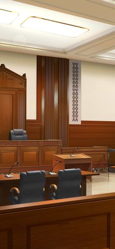 an empty courtroom is shown with chairs in front of the desk and behind the judge's bench