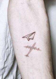 a man with a tattoo on his arm has an airplane and the word love written in it