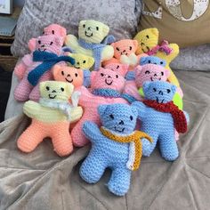 there are many crocheted teddy bears on the bed