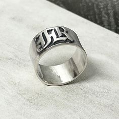 ♥ 925 sterling silver Old English Ring for Men is a personalized handmade ring that features a 12mm wide band and is adorned with Old English letters spelling out a boy's name. This ring type is typically designed to be unique and special, tailored to the individual's preferences. The specific style of lettering used in Old English can vary, but it typically features ornate and elaborate characters that give the ring a distinct and stylish aesthetic. ♥ S I Z E  &  M A T E R I A LS: ★ STYLE:  Old Cheap Silver Engraved Stainless Steel Ring, Old English Names, Old English Letters, English Name, Stylish Aesthetic, Best Gifts For Him, Name Ring, English Letters, Name Rings