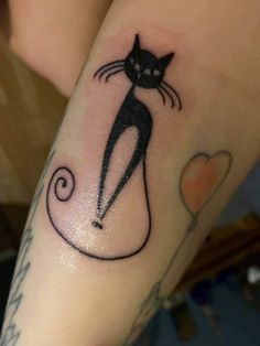 a black cat tattoo on the arm