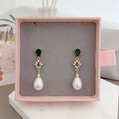 * DETAILS * - Emerald Crystal Glass Post Earrings - Aquamarine Crystal Glass post Earrings  - Teardrop Shaped Synthetic White Pearls  Metal: Bright / shiny gold plated brass 🎁A designer pull drawer pink gift box is available when the gift wrapping option is chosen. ------------------------------------------ * CARE TIPS * ⭐️TO PREVENT TARNISH: Keep your jewellery in airtight plastic bags. It won't tarnish if it isn't exposed to air. The worst place to leave your jewellery is in a steamy bathroom. Wipe with a soft cloth after wearing. - Perfumes: Be sure any perfume or lotions are completely absorbed into skin. - Hair products: Apply all hair products before putting on jewelry. - Swimming: Remove all jewelry before swimming or getting into hot tubes. - No sunlight: Store away from heat, dir Green Dangle Clip-on Earrings For Wedding, Green Teardrop Pearl Earrings For Wedding, Green Drop Pearl Earrings For Wedding, Classic Green Earrings For Wedding, Elegant Green Clip-on Earrings For Wedding, Green Clip-on Earrings For Wedding, Elegant Green Pearl Drop Bridal Earrings, Green Clip-on Wedding Earrings, Pink Gift Box