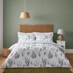 a bed in a bedroom with green walls and a wicker basket on the headboard