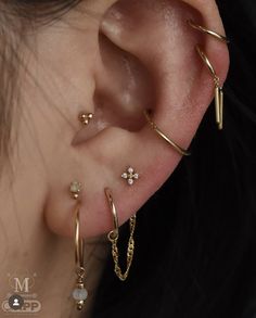 a close up of a person's ear with three different types of piercings