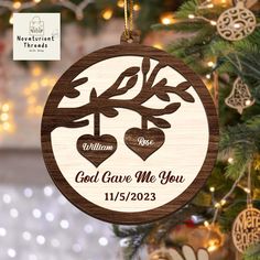 a wooden ornament with two hearts hanging from a christmas tree, and the words god gave me you on it