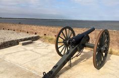 an old cannon is on display near the water