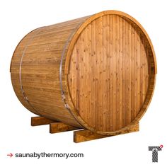 a large wooden barrel sitting on top of a wooden stand next to a white background