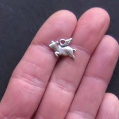 Flying pig antique silver tone charms, in a zinc alloy metal. Measurements: 15mm x 10mm Hole Size: 2mm You will receive 12 charms. Need more? Just send us a message through the contact us form, instant chat, or at mailto:info@bohemianfindings.com. Bulk pricing is available! All of our products are lead and cadmium free and nickel safe. As they contain small parts, all items are for adult jewelry/craft making use only, not intended for children under the age of 15. Pigs Fly, Flying Pig, Resin Jewelry, Pigs, Crafts To Make, Jewelry Crafts, Zinc Alloy, Floral Rings, Antique Silver