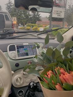 a car dashboard with flowers in the passenger seat