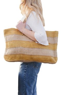 Perfect for an afternoon at the market, a day at the beach or a weekend adventure, this packable jute tote makes an ideal companion on any outing. It's handwoven in Bangladesh using traditional techniques and botanic dyes that give it an earthy, one-of-a-kind look and feel. 23"W x 14"H x 4"D Jute Spot clean Imported Summer Burlap Tote Bag, Artisan Tote Beach Bag For Travel, Artisan Summer Bags For Everyday Use, Artisan Beach Bag Tote For Travel, Summer Beach Bag In Burlap For Everyday Use, Artisan Beach Tote Bag For Travel, Rectangular Linen Beach Bag, Artisan Bags For Everyday Summer Use, Artisan Travel Beach Bag Tote