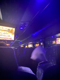 the inside of a bus with people playing video games