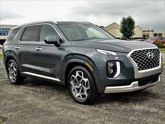 a gray suv parked in a parking lot