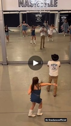 people are dancing in an indoor dance studio