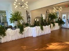 there are many plants on the tables at this wedding reception, and it looks like they were made from cloths