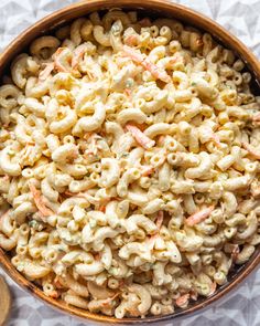 a bowl filled with macaroni salad on top of a table