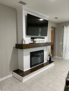 a living room with a fireplace and television mounted on the wall