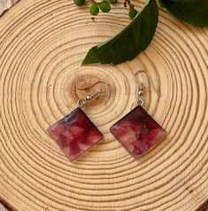 Brighten up your accessory collection with our Maroon Long Square Resin Earrings. These multicolored dangle earrings are designed to make a statement, adding a vibrant pop of color to any outfit. They are made with small pieces of resin in various colors of the same tone mixed giving the earrings a multicolored look.  These earrings feature long, square-shaped resin pieces that dangle gracefully, catching the light with every movement. The bold, multicolored design makes them a perfect choice fo Trendy Resin Jewelry With Matching Earrings, Trendy Red Resin Earrings, Handmade Red Earrings For Her, Handmade Red Earrings Gift For Her, Resin Jewelry For Summer Gifts, Handmade Red Earrings As Gift For Her, Summer Gift Jewelry Made Of Resin, Bohemian Rectangular Jewelry For Summer, Bohemian Rectangular Summer Jewelry