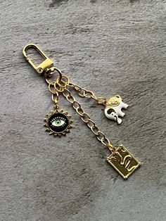 This purse charm is made with unique charms with a gold tone.  This purse chain charm would fancy up any purse. This purse charm would make a gift for someone special. This charm is almost 4.5  inches long.  This listing is for the chain with charms only.  Bag, books and photo props are not included.  Please feel free to message me with any questions or custom orders Gold Bag Charm With Charms For Everyday Use, Gold Jewelry With Removable Charms For Everyday, Gold Keychain Bag Charm For Everyday Use, Gold Rectangular Bag Charm For Gift, Gold Bag Charm With Logo, Gold Bag Charm With Logo For Everyday Use, Gold Keychain With Logo Charm As Gift, Rectangular Gold Bag Charm For Gift, Gold Metal Keychain For Gift